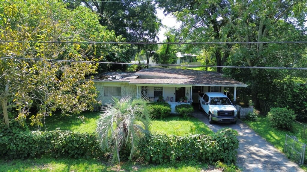 Small Jacksonville house with a covered front porch and a truck in the driveway
